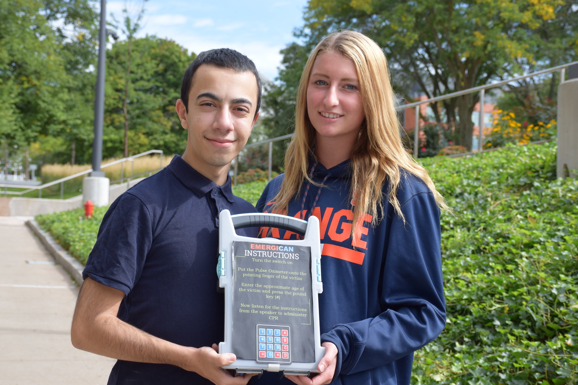 Two students with their prototype