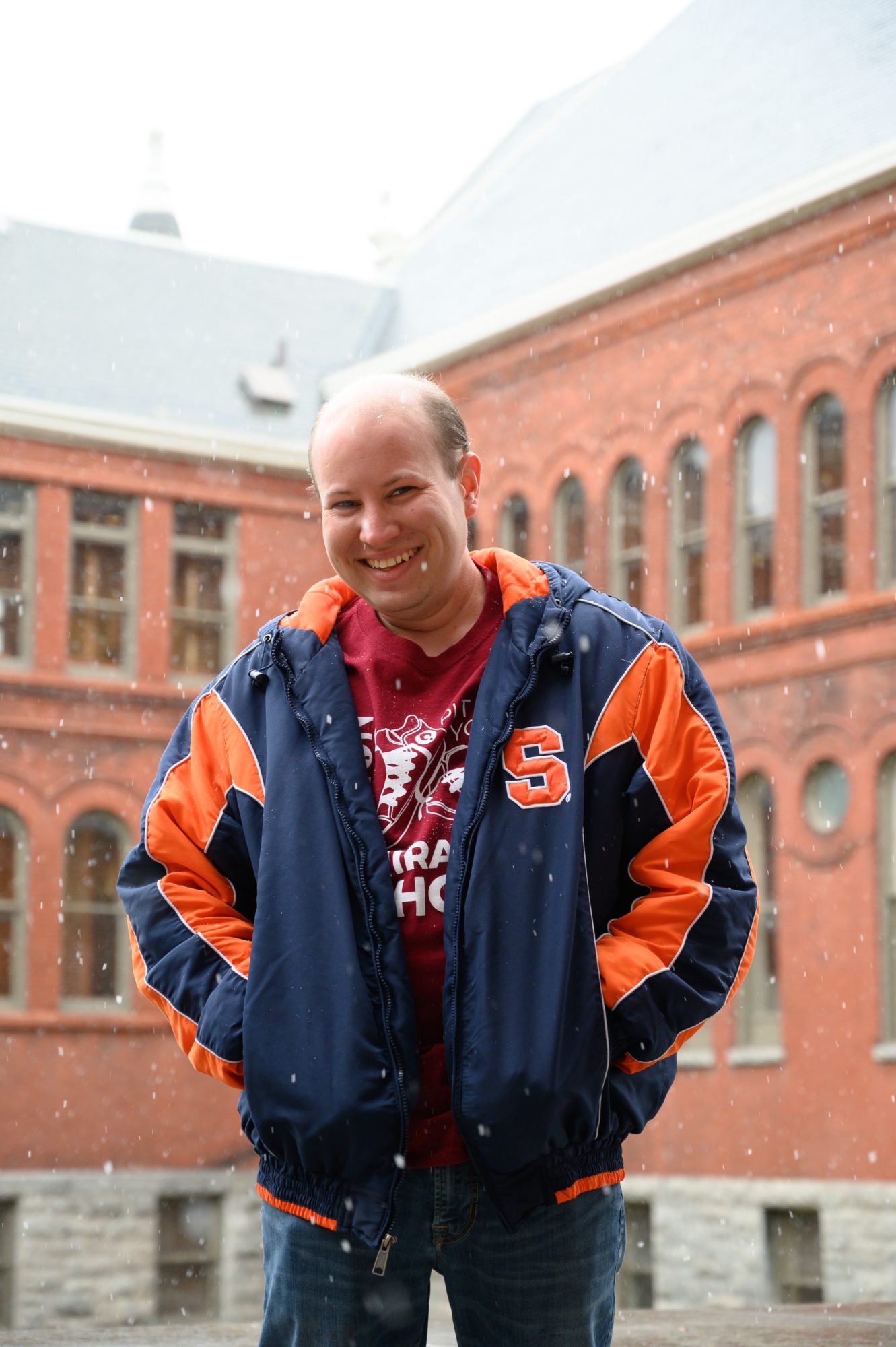 Student in a SU jacket smiling