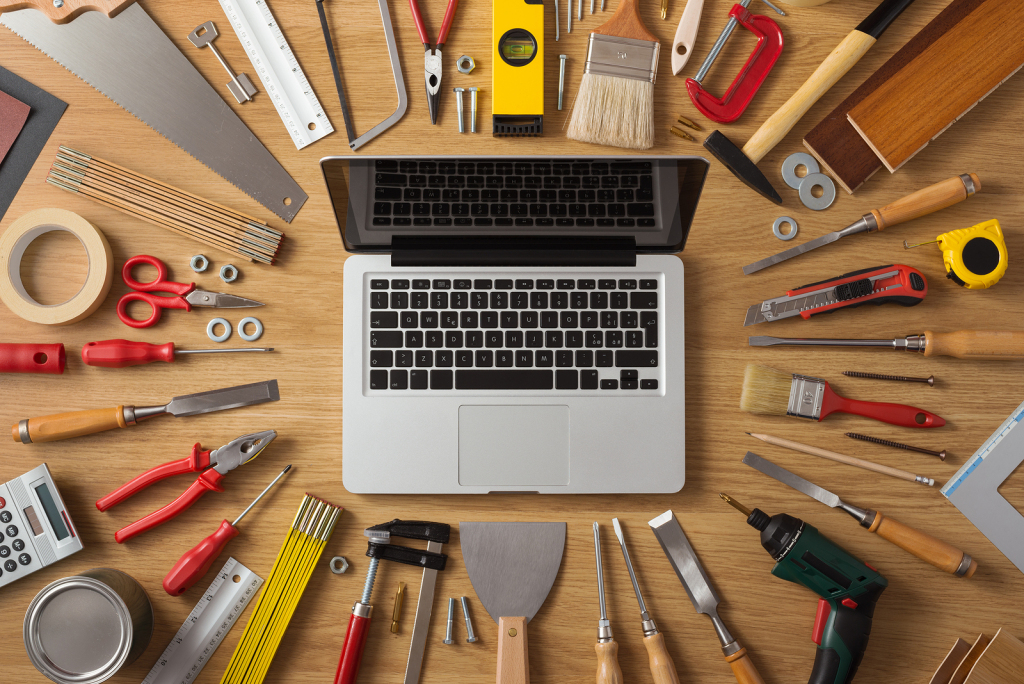 laptop on a worktable with tools