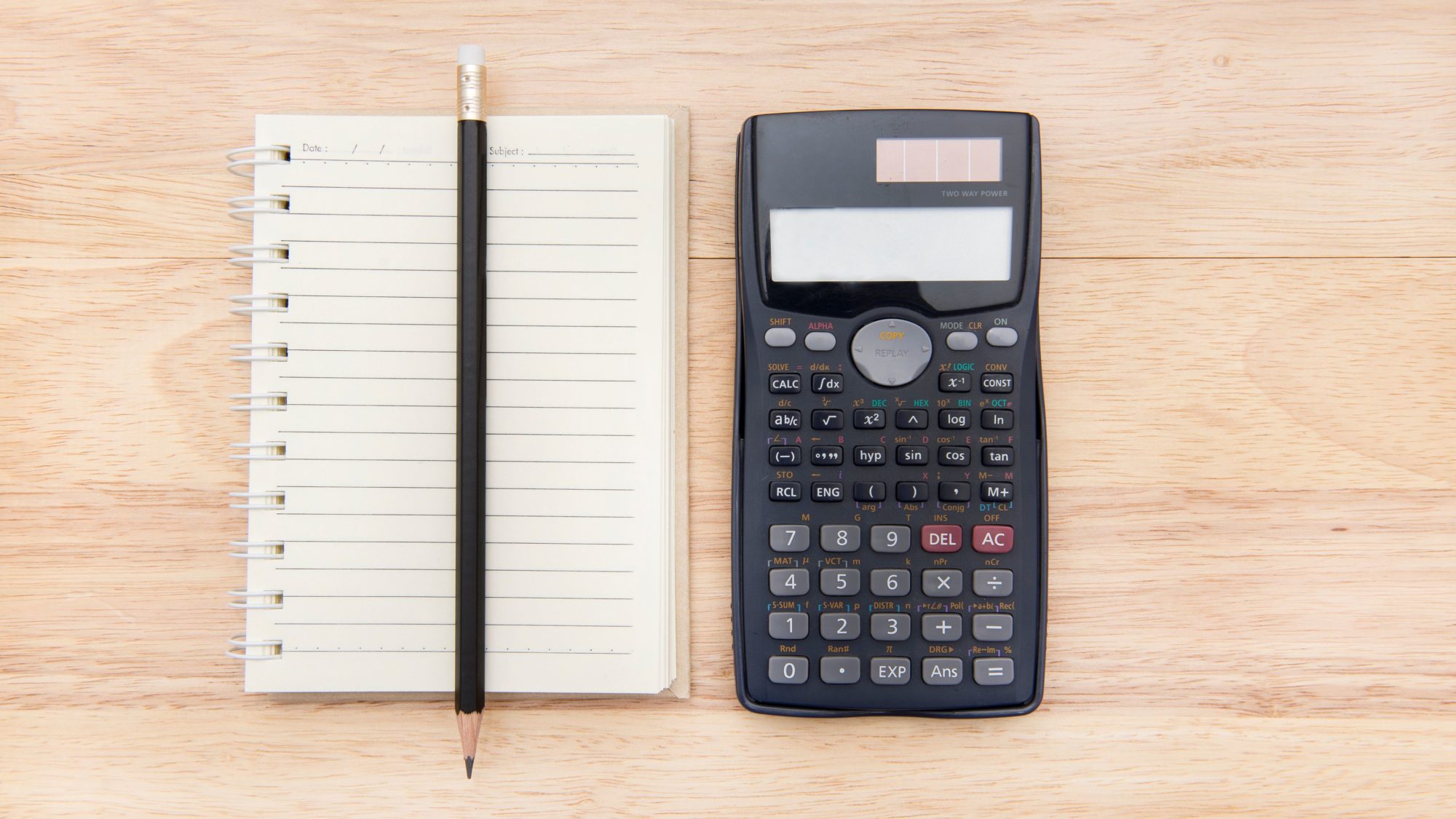 notepad and calculator on a desk