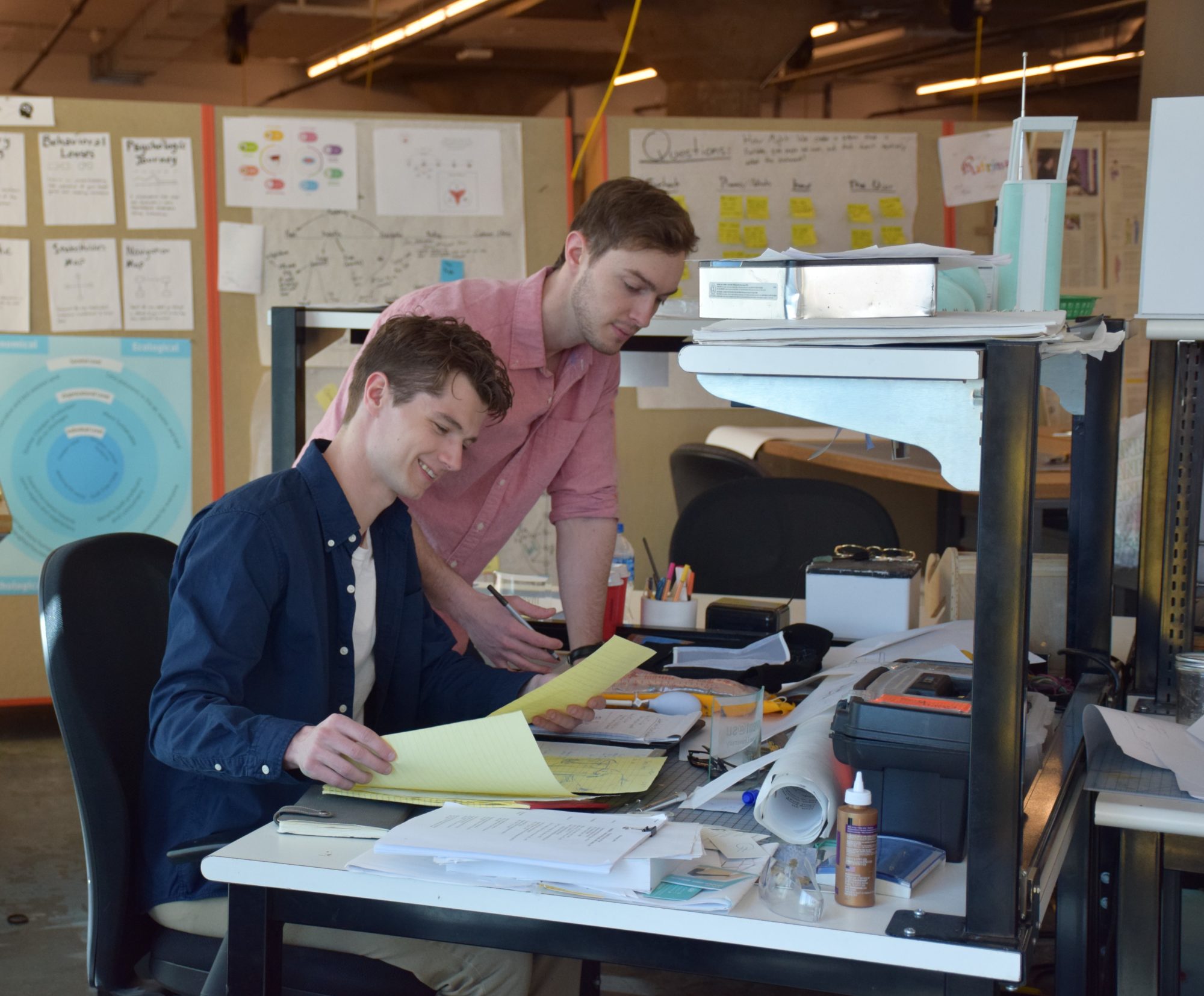 Two students working in SU design studio