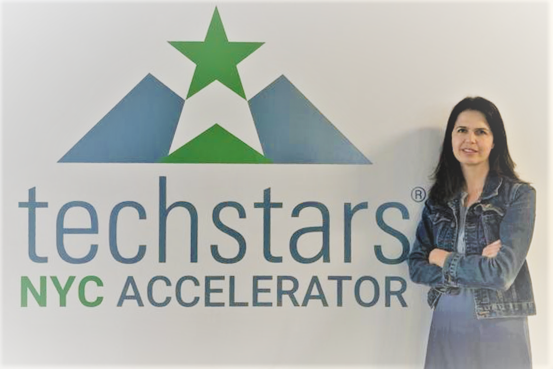 Woman in front of Techstars sign