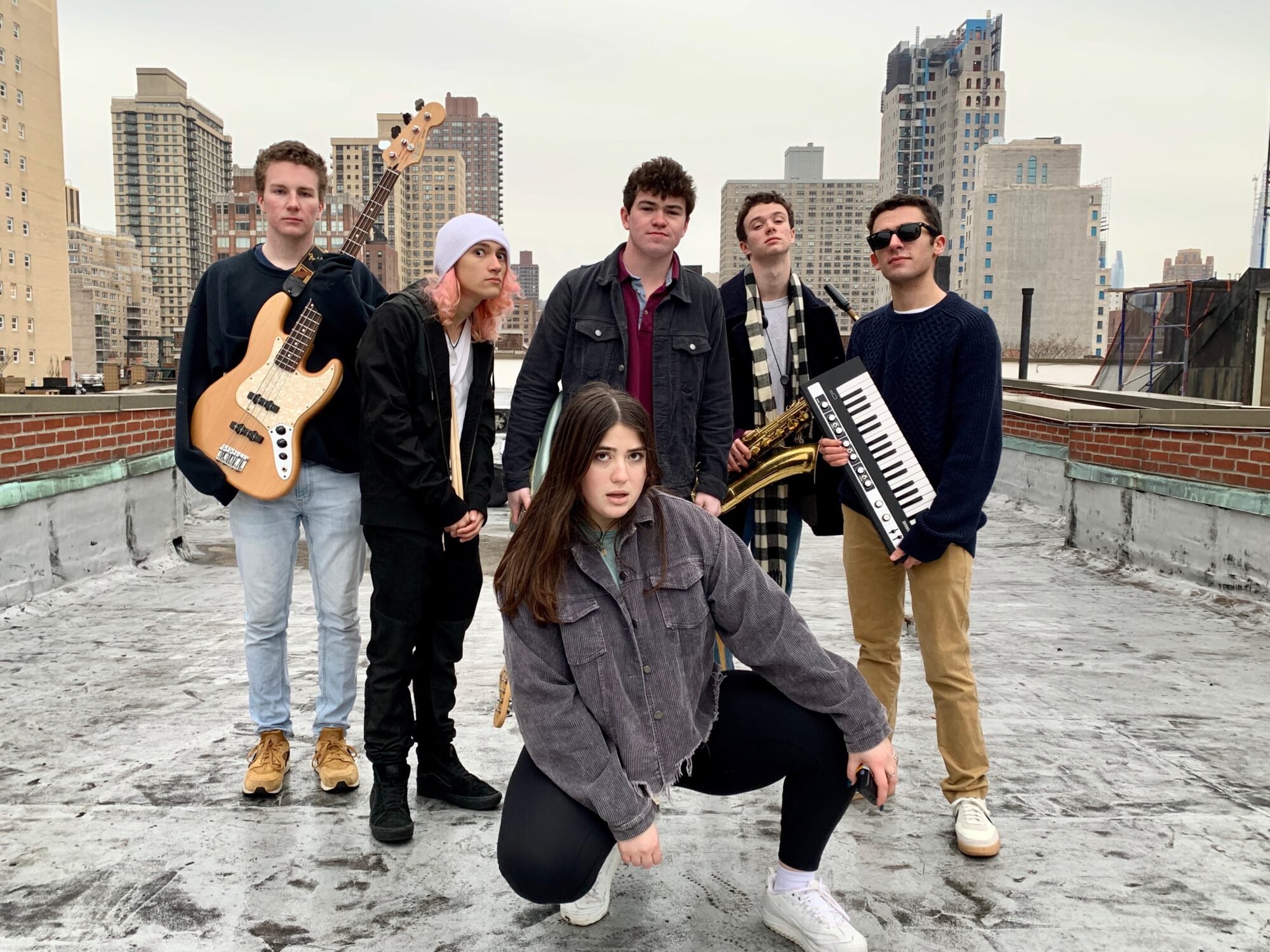 group of bandmembers on a rooftop in syracuse