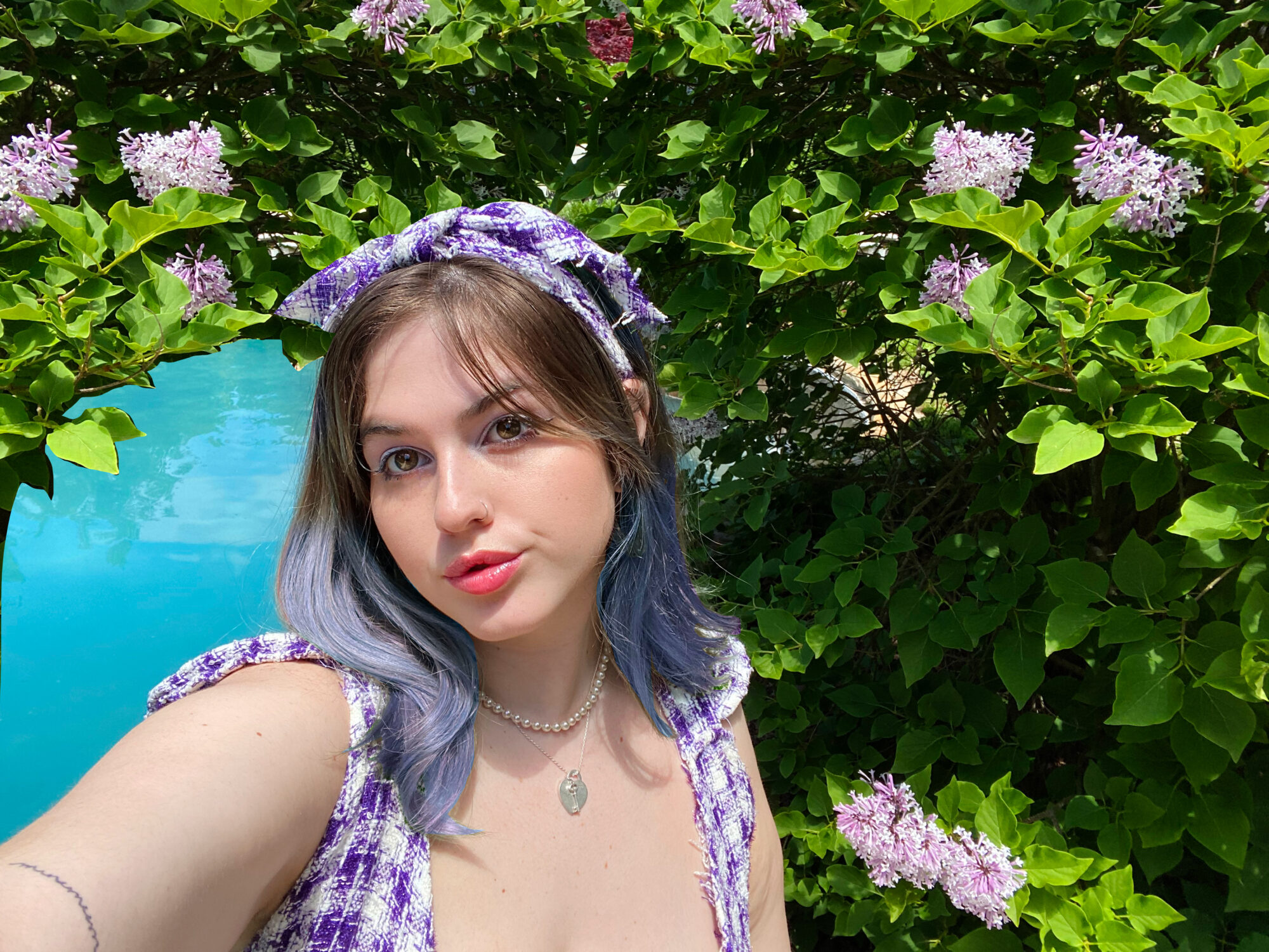 student with aqua water and purple flowers