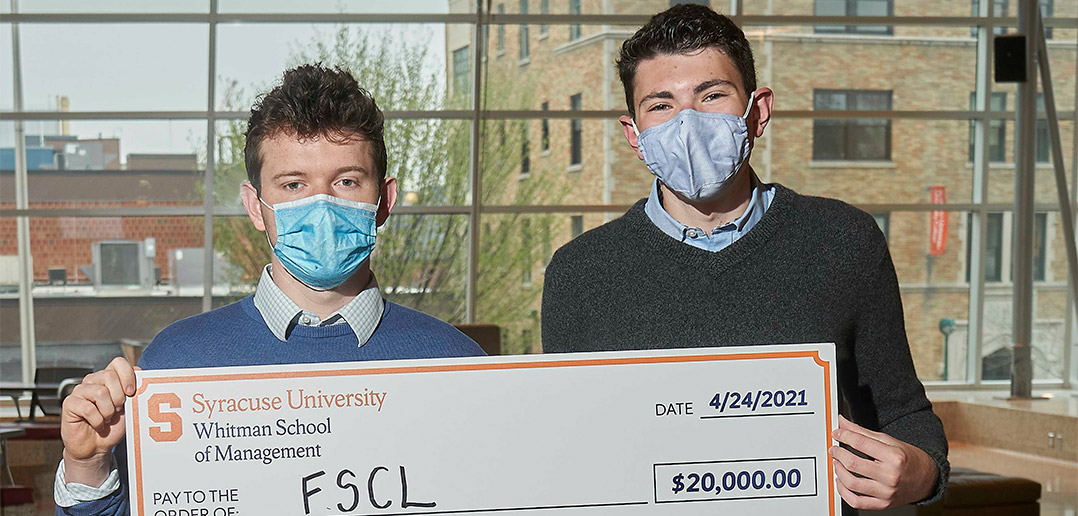 students holding a prize check