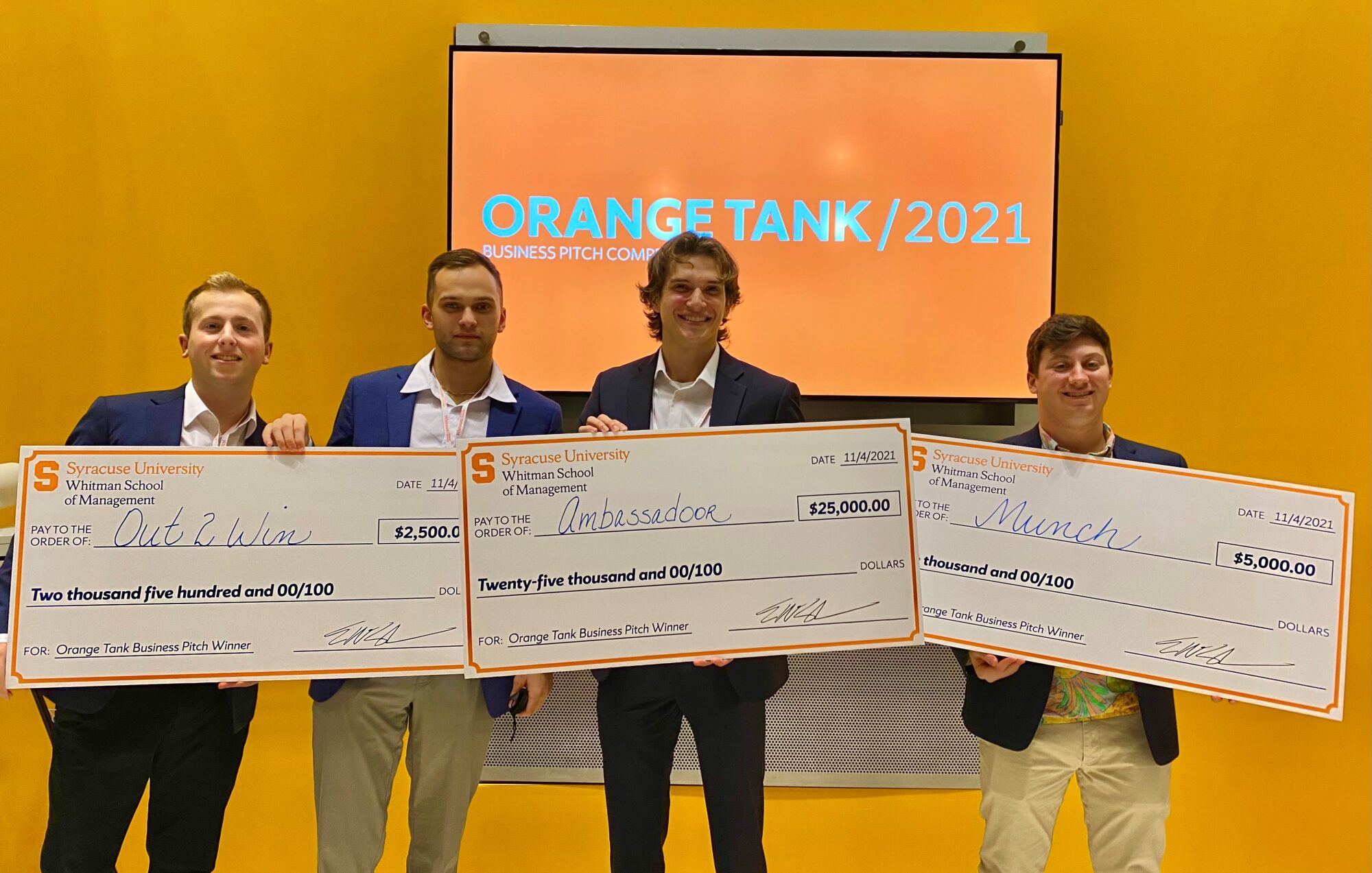 group of people holding prize checks