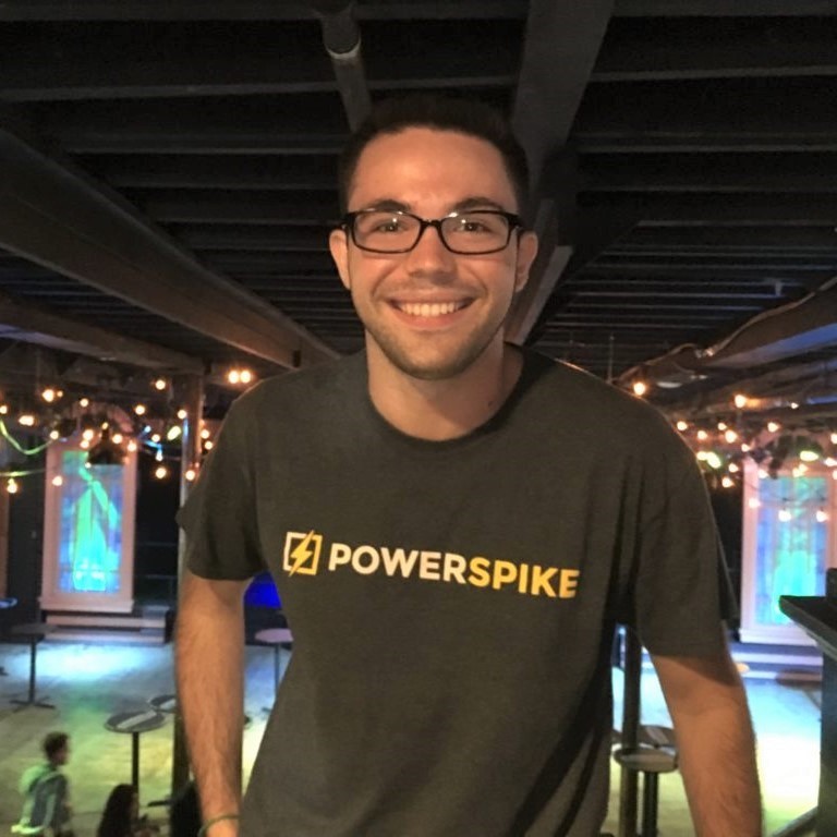headshot of a man in a t-shirt with a PowerSpike logo