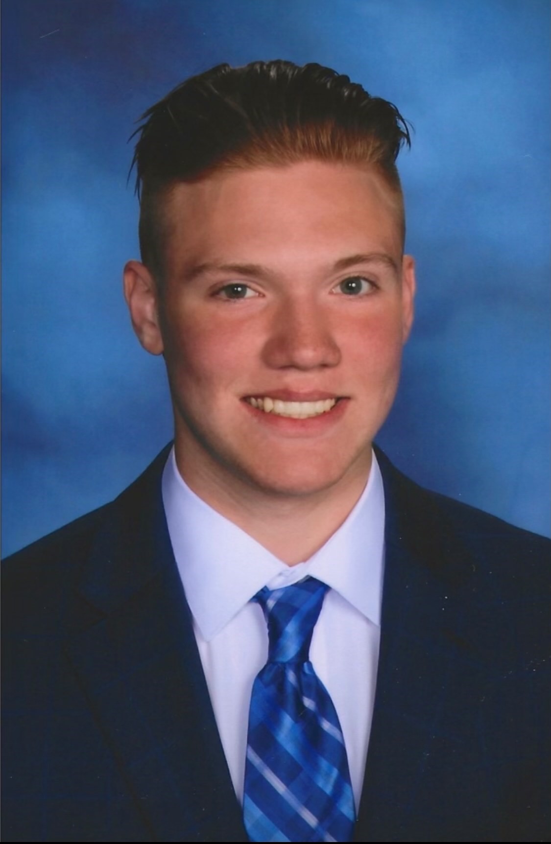headshot of a student in a suit