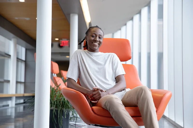 photo of a woman sitting in an orange chair